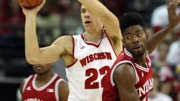 Jan 26, 2016; Madison, WI, USA; Wisconsin Badgers forward Ethan Happ (22) passes the ball as Indiana Hoosiers guard Robert Johnson (4) looks on during the first half at the Kohl Center. Mandatory Credit: Mary Langenfeld-USA TODAY Sports
