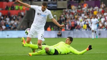 SWANSEA, WALES - SEPTEMBER 11: Swansea player Gylfi Sigurdsson is brought down by Thibaut Courtois for the Swansea penalty during the Premier League match between Swansea City and Chelsea at Liberty Stadium on September 11, 2016 in Swansea, Wales. (Photo by Stu Forster/Getty Images)