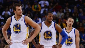 October 24, 2013; Oakland, CA, USA; Golden State Warriors center Andrew Bogut (12), shooting guard Andre Iguodala (9), and point guard Stephen Curry (30) look on during the fourth quarter against the Portland Trail Blazers at Oracle Arena. The Trail Blazers defeated the Warriors 90-74. Mandatory Credit: Kyle Terada-USA TODAY Sports