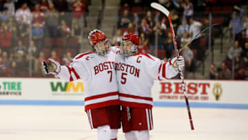 BOSTON, MA - NOVEMBER 6: BU's Charlie McAvoy (7, left) and Matt Grzelcyk (5) celebrate Grzelcyk's goal during the first period of Boston University's hockey game against Northeastern University at Agganis Arena in Boston on Nov. 6, 2015. (Photo by Craig F. Walker/The Boston Globe via Getty Images)