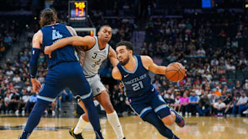 Mar 30, 2022; San Antonio, Texas, USA; Memphis Grizzlies guard Tyus Jones (21) dribbles past San Antonio Spurs forward Keldon Johnson (3) in the first half at the AT&T Center. (Daniel Dunn-USA TODAY Sports)