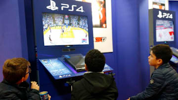 PARIS, FRANCE - OCTOBER 27: Visitors play the video game "NBA 2K 17" developed byVisual Concepts and published by 2K Sports on Sony PlayStation game console PS4 during the "Paris Games Week"on October 27, 2016 in Paris, France. "Paris Games Week" is an international trade fair for video games to be held from October 27 to October 31, 2016. (Photo by Chesnot/Getty Images)