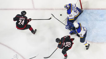 Feb 21, 2023; Raleigh, North Carolina, USA; St. Louis Blues goaltender Jordan Binnington (50) stops the shot attempt by Carolina Hurricanes center Seth Jarvis (24) during the second period at PNC Arena. Mandatory Credit: James Guillory-USA TODAY Sports