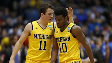 Mar 16, 2016; Dayton, OH, USA; Michigan Wolverines guard Andrew Dakich (11) and guard Derrick Walton Jr. (10) celebrate during the second half against the Tulsa Golden Hurricane in the First Four of the NCAA men