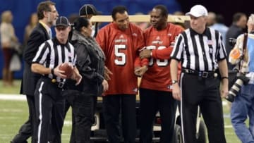 Jan 2, 2013; New Orleans, LA, USA; Former boxing champion Muhammad Ali (5) and Yolanda Ali during coin toss for the Sugar Bowl game with the Louisville Cardinals taking on the Florida Gators at the Mercedes-Benz Superdome. Mandatory Credit: John David Mercer-USA TODAY Sports