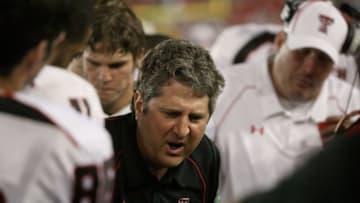 HOUSTON - SEPTEMBER 26: Head coach Mike Leach of the Texas Tech Red Raiders talks with his defense while playing against the University of Houston at Robertson Stadium on September 26, 2009 in Houston, Texas. (Photo by Thomas B. Shea/Getty Images)