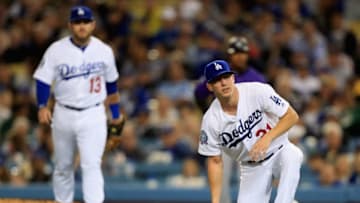 LOS ANGELES, CA - MAY 21: Max Muncy #13 looks on as Walker Buehler #21 of the Los Angeles Dodgers takes a knee after being hit by a line drive from Trevor Story #27 of the Colorado Rockies during the fifth inning of a game at Dodger Stadium on May 21, 2018 in Los Angeles, California. (Photo by Sean M. Haffey/Getty Images)
