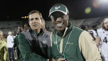 Nov 26, 2015; Orlando, FL, USA; South Florida Bulls head coach Willie Taggart (right) is all smiles after being congratulated by USF Athletic Director Mark Harlan during the second half of a football game at Bright House Networks Stadium. South Florida won 44-3. Mandatory Credit: Reinhold Matay-USA TODAY Sports