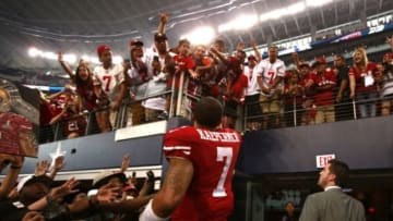 Sep 7, 2014; Arlington, TX, USA; San Francisco 49ers quarterback Colin Kaepernick (7) throws his gloves to fans after the game against the Dallas Cowboys at AT&T Stadium. San Francisco beat Dallas 28-17. Mandatory Credit: Tim Heitman-USA TODAY Sports