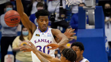 Jan 9, 2021; Lawrence, Kansas, USA; Oklahoma Sooners guard Alondes Williams (15) passes the ball against Kansas Jayhawks guard Ochai Agbaji (30) during the first half at Allen Fieldhouse. Mandatory Credit: Denny Medley-USA TODAY Sports