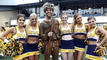 Sep 6, 2014; Morgantown, WV, USA; West Virginia Mountaineers mascot Michael Garcia poses with the WVU cheerleaders before the Mountaineers host the Towson Tigers at Milan Puskar Stadium. Mandatory Credit: Charles LeClaire-USA TODAY Sports