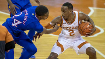 Feb 23, 2021; Austin, Texas, USA; Texas Longhorns guard Matt Coleman III (2) is fouled by Kansas Jayhawks guard Bryce Thompson (24) in overtime of an NCAA college basketball game at the Frank Erwin Center. Mandatory Credit: Ricardo B. Brazziell/American-Statesman-USA TODAY Sports