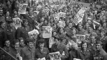 American servicemen and women in Paris celebrate on V-J Day, marking the end of World War II.