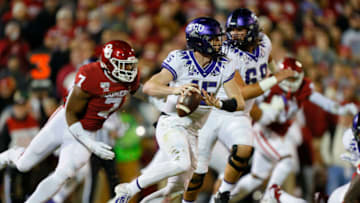 NORMAN, OK - NOVEMBER 23: Quarterback Max Duggan #15 of the TCU Horned Frogs rolls out as he looks for a receiver while being chased by defensive lineman Ronnie Perkins #7 of the Oklahoma Sooners in the first quarter on November 23, 2019 at Gaylord Family Oklahoma Memorial Stadium in Norman, Oklahoma. OU held on to win 28-24. (Photo by Brian Bahr/Getty Images)