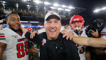 ORLANDO, FLORIDA - DECEMBER 21: Head coach Hugh Freeze of the Liberty Flames celebrates with his team after defeating the Georgia Southern Eagles in the 2019 Cure Bowl at Exploria Stadium on December 21, 2019 in Orlando, Florida. (Photo by James Gilbert/Getty Images)