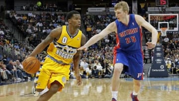 Mar 19, 2014; Denver, CO, USA; Detroit Pistons small forward Kyle Singler (25) guards Denver Nuggets point guard Aaron Brooks (0) in the fourth quarter at the Pepsi Center. The Nuggets won 118-109. Mandatory Credit: Isaiah J. Downing-USA TODAY Sports