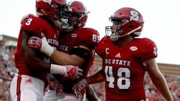 Oct 1, 2016; Raleigh, NC, USA; North Carolina State Wolfpack receiver Kelvin Harmon (3) is congratulated by teammates after scoring during the second half against the Wake Forest Deamon Deacons at Carter Finley Stadium. The Wolfpack won 33-16. Mandatory Credit: Rob Kinnan-USA TODAY Sports