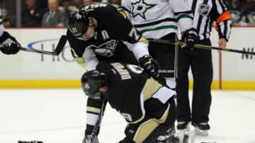 Oct 16, 2014; Pittsburgh, PA, USA; Pittsburgh Penguins right wing Pascal Dupuis (9) is help by teammate Evgeni Malkin (71) after being injured during the second period of an NHL game against the Dallas Stars at Consol Energy Center. Mandatory Credit: Don Wright-USA TODAY Sports