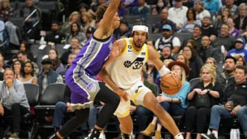 Mar 25, 2023; Sacramento, California, USA; Utah Jazz guard Johnny Juzang (33) dribbles against Sacramento Kings forward Kessler Edwards (17) during the third quarter at Golden 1 Center. Mandatory Credit: Darren Yamashita-USA TODAY Sports