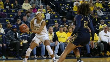 ANN ARBOR, MI - NOVEMBER 23: Michigan Wolverines forward Kayla Robbins (5) looks to pass the ball while being defended by Notre Dame Fighting Irish guard Anaya Peoples (21) during a regular season non-conference game between the Notre Dame Fighting Irish and the Michigan Wolverines on November 23, 2019, at Crisler Center in Ann Arbor, Michigan. (Photo by Scott W. Grau/Icon Sportswire via Getty Images)