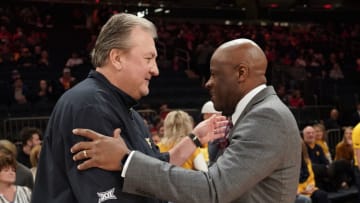 St. John's basketball head coach greets West Virginia head coach Bob Huggins. (Photo by Porter Binks/Getty Images)