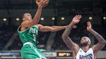 Feb 20, 2015; Sacramento, CA, USA; Boston Celtics guard Avery Bradley (0) goes up for the shot against Sacramento Kings center DeMarcus Cousins (15) during the fourth quarter at Sleep Train Arena. The Sacramento Kings defeated the Boston Celtics 109-101. Mandatory Credit: Ed Szczepanski-USA TODAY Sports