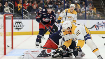 Oct 20, 2022; Columbus, Ohio, USA; Columbus Blue Jackets goaltender Elvis Merzlikins (back) attempts a save as Nashville Predators center Ryan Johansen (92) scores a goal in the first period at Nationwide Arena. Mandatory Credit: Aaron Doster-USA TODAY Sports