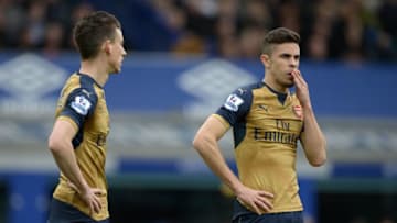 Arsenal's Brazilian defender Gabriel (R) and Arsenal's French defender Laurent Koscielny talk during the English Premier League football match between Everton and Arsenal at Goodison Park in Liverpool, north west England on March 19, 2016. / AFP / OLI SCARFF / RESTRICTED TO EDITORIAL USE. No use with unauthorized audio, video, data, fixture lists, club/league logos or 'live' services. Online in-match use limited to 75 images, no video emulation. No use in betting, games or single club/league/player publications. / (Photo credit should read OLI SCARFF/AFP/Getty Images)
