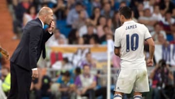 Real Madrid's French coach Zinedine Zidane (L) talks with Real Madrid's Colombian midfielder James Rodriguez during the Spanish league football match Real Madrid CF vs Villarreal CF at the Santiago Bernabeu stadium in Madrid on September 21, 2016. / AFP / CURTO DE LA TORRE (Photo credit should read CURTO DE LA TORRE/AFP/Getty Images)