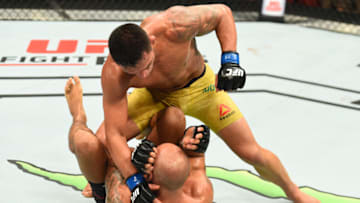 WINNIPEG, CANADA - DECEMBER 16: (R-L) Rafael Dos Anjos of Brazil punches Robbie Lawler in their welterweight bout during the UFC Fight Night event at Bell MTS Place on December 16, 2017 in Winnipeg, Manitoba, Canada. (Photo by Josh Hedges/Zuffa LLC/Zuffa LLC via Getty Images)