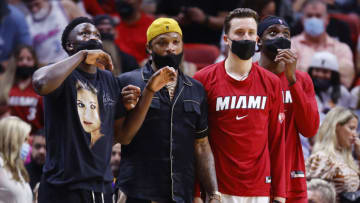 Victor Oladipo #4, P.J. Tucker #17, Duncan Robinson #55 and Zylan Cheatham #45 of the Miami Heat look on against the Washington Wizards (Photo by Michael Reaves/Getty Images)