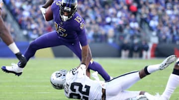 BALTIMORE, MARYLAND - NOVEMBER 25: Wide Receiver Michael Crabtree #15 of the Baltimore Ravens is tackled after a catch by cornerback Rashaan Melvin #22 of the Oakland Raiders in the third quarter at M&T Bank Stadium on November 25, 2018 in Baltimore, Maryland. (Photo by Patrick Smith/Getty Images)