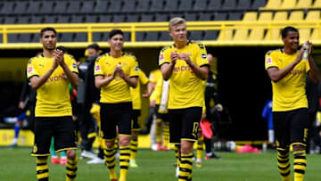 DORTMUND, GERMANY - MAY 16: Erling Haaland of Borussia Dortmund (C) and teammates celebrate following the Bundesliga match between Borussia Dortmund and FC Schalke 04 at Signal Iduna Park on May 16, 2020 in Dortmund, Germany. The Bundesliga and Second Bundesliga is the first professional league to resume the season after the nationwide lockdown due to the ongoing Coronavirus (COVID-19) pandemic. All matches until the end of the season will be played behind closed doors. (Photo by Martin Meissner/Pool via Getty Images)