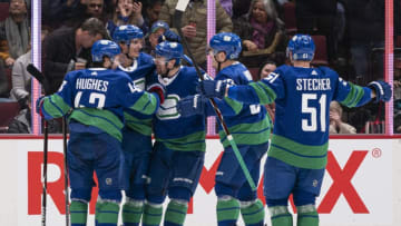 VANCOUVER, BC - JANUARY 18: Loui Eriksson #21 of the Vancouver Canucks is congratulated by teammates Quinn Hughes #43, Tanner Pearson #70, Bo Horvat #53 and Troy Stecher #51 after scoring a goal against the San Jose Sharks in NHL action on January, 18, 2020 at Rogers Arena in Vancouver, British Columbia, Canada. (Photo by Rich Lam/Getty Images)