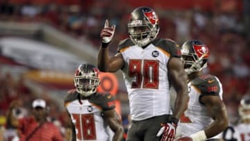 Aug 16, 2014; Tampa, FL, USA; Tampa Bay Buccaneers defensive end Michael Johnson (90) reacts after he recovered a fumble during the second quarter against the Miami Dolphins at Raymond James Stadium. Mandatory Credit: Kim Klement-USA TODAY Sports