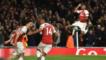 Arsenal's Gabonese striker Pierre-Emerick Aubameyang (2nd L) celebrates with Arsenal's German midfielder Mesut Ozil (L) as (Arsenal's Nigerian striker Alex Iwobi reacts behind), after scoring their third goal during the English Premier League football match between Arsenal and Leicester City at the Emirates Stadium in London on October 22, 2018. (Photo by Glyn KIRK / IKIMAGES / AFP) / RESTRICTED TO EDITORIAL USE. No use with unauthorized audio, video, data, fixture lists, club/league logos or 'live' services. Online in-match use limited to 45 images, no video emulation. No use in betting, games or single club/league/player publications. (Photo credit should read GLYN KIRK/AFP/Getty Images)