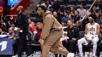 Nov 4, 2022; Detroit, Michigan, USA; Cleveland Cavaliers guard Donovan Mitchell (center) cheers on his teammates as they hold a lead over the Detroit Pistons in the second half at Little Caesars Arena. Mandatory Credit: Allison Farrand-USA TODAY Sports