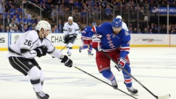 Jun 9, 2014; New York, NY, USA; New York Rangers left wing Rick Nash (61) skates with the puck against Los Angeles Kings defenseman Slava Voynov (26) during the second period in game three of the 2014 Stanley Cup Final at Madison Square Garden. Mandatory Credit: Brad Penner-USA TODAY Sports