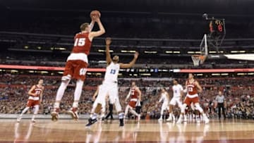 Apr 6, 2015; Indianapolis, IN, USA; Wisconsin Badgers forward Sam Dekker (15) shoots a three over Duke Blue Devils guard Matt Jones (13) in the second half in the 2015 NCAA Men
