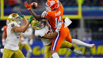 ARLINGTON, TEXAS - DECEMBER 29: Diondre Overton #14 of the Clemson Tigers competes for the ball with Julian Love #27 of the Notre Dame Fighting Irish in the second half during the College Football Playoff Semifinal Goodyear Cotton Bowl Classic at AT&T Stadium on December 29, 2018 in Arlington, Texas. (Photo by Kevin C. Cox/Getty Images)