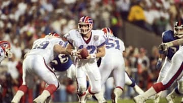 Jan 27, 1991; Tampa, FL, USA; FILE PHOTO; Buffalo Bills quarterback Jim Kelly (12) carries the ball against the New York Giants during Super Bowl XXV at Tampa Stadium. The Giants defeated the Bills 19-20. Mandatory Credit: USA TODAY Sports