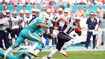 Jan 1, 2017; Miami Gardens, FL, USA; New England Patriots wide receiver Julian Edelman (11) carries the ball past Miami Dolphins middle linebacker Kiko Alonso (47) during the second half at Hard Rock Stadium. Mandatory Credit: Steve Mitchell-USA TODAY Sports
