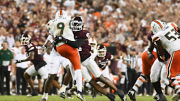 COLLEGE STATION, TEXAS - SEPTEMBER 17: Edgerrin Cooper #45 of the Texas A&M Aggies tackles Tyler Van Dyke #9 of the Miami Hurricanes after a pass during the second half of the game at Kyle Field on September 17, 2022 in College Station, Texas. (Photo by Jack Gorman/Getty Images)