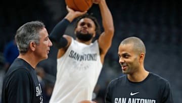 Tony Parker #9 of the San Antonio Spurs talks with assistant coach Chip Engelland before the start of their game against the Dallas Mavericks at AT&T Center on November 27, 2017 in San Antonio, Texas. (Photo by Ronald Cortes/Getty Images)