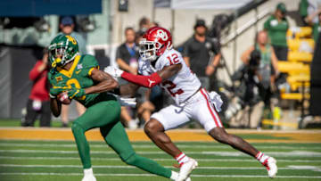 Nov 13, 2021; Waco, Texas, USA; Baylor Bears wide receiver R.J. Sneed (0) catches a pass as Oklahoma Sooners defensive back Key Lawrence (12) defends during the first half at McLane Stadium. Mandatory Credit: Jerome Miron-USA TODAY Sports