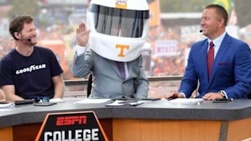 Sep 10, 2016; Bristol, TN, USA; ESPN analyst Lee Corso puts on a Tennessee Volunteers racing helmet as he makes his game pick with NASCAR Sprint Cup driver Dale Earnhardt Jr. and ESPN commentator Kirk Herbstreit prior to the Battle at Bristol football game between the Virginia Tech Holies and Tennessee Volunteers at Bristol Motor Speedway. Mandatory Credit: Christopher Hanewinckel-USA TODAY Sports