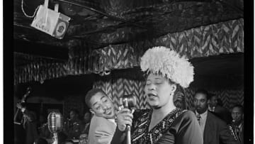 Ella Fitzgerald sings in New York City as Dizzy Gillespie looks on.