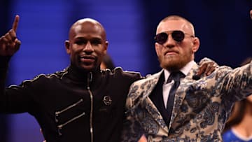 LAS VEGAS, NV - AUGUST 25: (L-R) Floyd Mayweather Jr. and Conor McGregor pose for pictures during a news conference after Mayweather's 10th-round TKO victory in their super welterweight boxing match on August 26, 2017 at T-Mobile Arena in Las Vegas, Nevada. (Photo by Jeff Bottari/Zuffa LLC/Zuffa LLC via Getty Images)