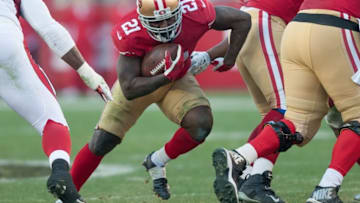 Dec 28, 2014; Santa Clara, CA, USA; San Francisco 49ers running back Frank Gore (21) rushes for a gain against the Arizona Cardinals during the third quarter at Levi