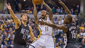 Nov 25, 2016; Indianapolis, IN, USA; Indiana Pacers guard Monta Ellis (11) shoots the ball while Brooklyn Nets center Brook Lopez (11) and guard Isaiah Whitehead (15) defend in the first half of the game at Bankers Life Fieldhouse. Mandatory Credit: Trevor Ruszkowski-USA TODAY Sports